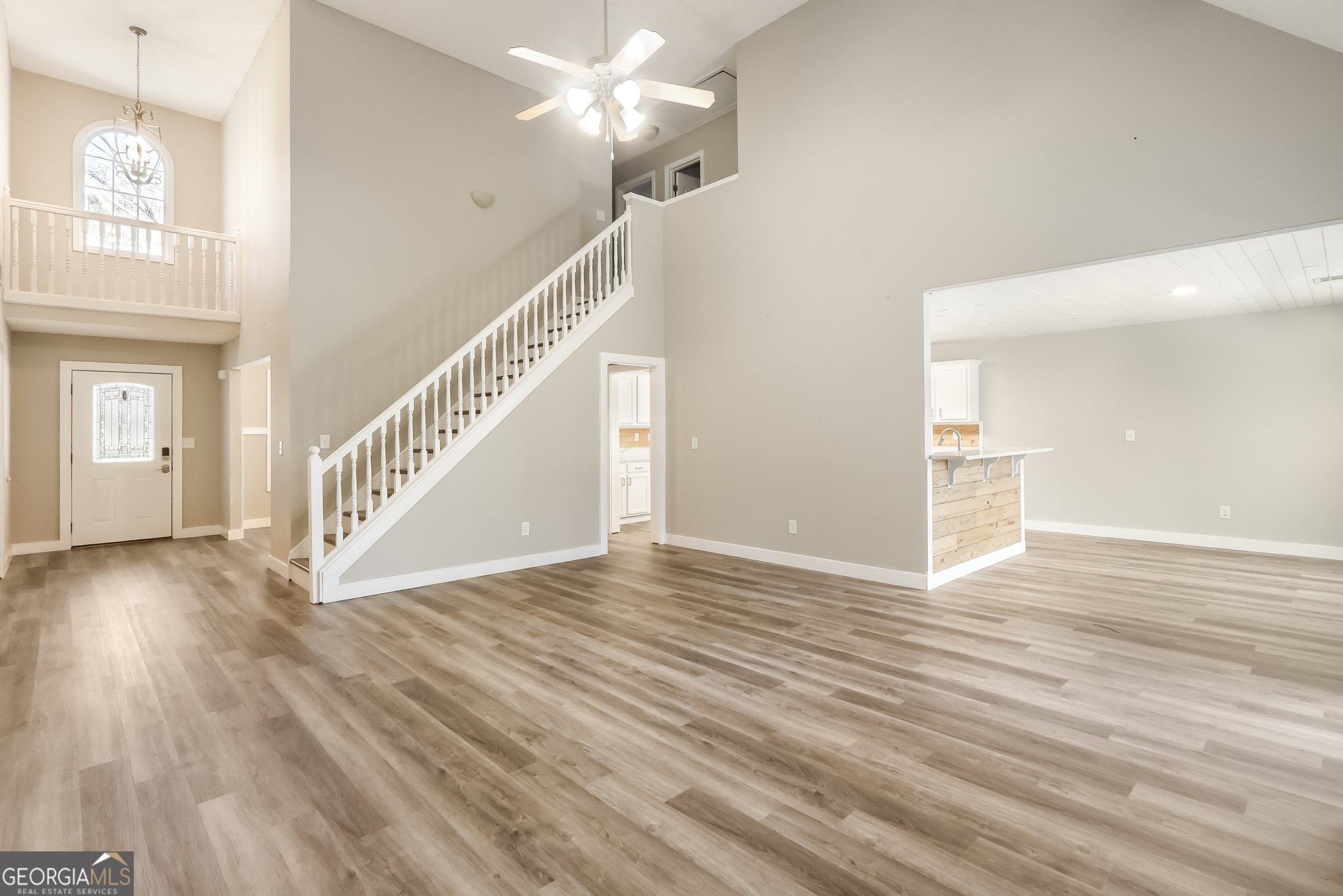 Bright two-story living room with fireplace